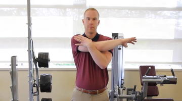 Rob Shirley, PT, DPT of South Shore Health demonstrates a shoulder stretch at the rehabilitation gym